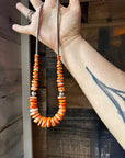 22 inch graduated orange spiny necklace with Sterling silver pearls