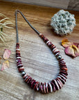 22 Inch graduated necklace more purple and orange spiny and sterling silver pearls