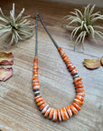 22 inch graduated orange spiny necklace with Sterling silver pearls