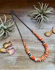 22 inch graduated orange spiny necklace with Sterling silver pearls