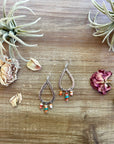 Orange spiny dangle earrings with turquoise